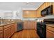 Kitchen featuring granite countertops, stainless steel appliances, and wood cabinetry at 3655 Chattahoochee Summit Se Dr # 16, Atlanta, GA 30339