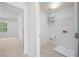 Well-lit laundry room featuring tile floors, washer hookups, and storage shelf for organization at 3655 Chattahoochee Summit Se Dr # 16, Atlanta, GA 30339