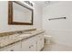 Bathroom featuring a granite countertop, framed mirror, and updated fixtures at 3690 Basswood Rd, Snellville, GA 30039