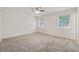 Bright bedroom with neutral carpet, two windows, and ample natural light at 3690 Basswood Rd, Snellville, GA 30039