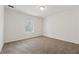 Carpeted bedroom featuring a ceiling light and natural lighting at 3690 Basswood Rd, Snellville, GA 30039