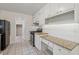 Kitchen features a range, white cabinets, granite countertops and ample storage at 3690 Basswood Rd, Snellville, GA 30039