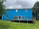 Exterior rear view of blue house with a wooden deck and grassy backyard at 5560 Old Bill Cook Rd, College Park, GA 30349
