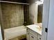 Tiled bathroom featuring a shower-tub combo and a single sink vanity at 5560 Old Bill Cook Rd, College Park, GA 30349