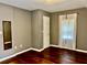 The bedroom features neutral paint, wood floors, a window with sheer curtains and a closet at 5560 Old Bill Cook Rd, College Park, GA 30349