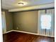 A bedroom with hardwood floors and windows covered by sheer curtains at 5560 Old Bill Cook Rd, College Park, GA 30349
