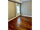 Bedroom featuring hardwood flooring, window with sheer curtains and gray walls at 5560 Old Bill Cook Rd, College Park, GA 30349