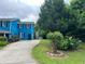 Home's exterior with a colorful facade, green lawn, and a variety of plantings at 5560 Old Bill Cook Rd, College Park, GA 30349
