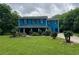 Two-story blue house with black shutters and a covered front porch offers an inviting curb appeal at 5560 Old Bill Cook Rd, College Park, GA 30349