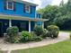 Charming home featuring a well-kept landscape design and a stone accent wall on the porch at 5560 Old Bill Cook Rd, College Park, GA 30349