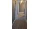 A hallway with carpet and neutral gray walls leads to doorways at 5560 Old Bill Cook Rd, College Park, GA 30349