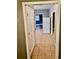 Hallway view with tiled floor leading to the kitchen and a bedroom with view to window at 5560 Old Bill Cook Rd, College Park, GA 30349