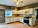 Bright kitchen features white cabinets, warm tile floors and stainless steel appliances at 5560 Old Bill Cook Rd, College Park, GA 30349