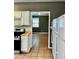 The kitchen features white cabinets, stainless steel range, and a view to another room at 5560 Old Bill Cook Rd, College Park, GA 30349