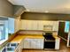 Kitchen with warm tile floor, gas range and views to another room at 5560 Old Bill Cook Rd, College Park, GA 30349