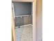 A simple laundry room with grey walls, checkered floors, a shelf, and space for a washer and dryer at 5560 Old Bill Cook Rd, College Park, GA 30349