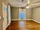 Bright living room with hardwood floors, neutral paint, and modern ceiling fan at 5560 Old Bill Cook Rd, College Park, GA 30349