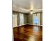 Bright living room featuring gleaming hardwood floors and natural light at 5560 Old Bill Cook Rd, College Park, GA 30349