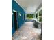 Spacious porch with stone tile flooring, and a stone accent wall at 5560 Old Bill Cook Rd, College Park, GA 30349