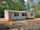 Charming single-story home featuring neutral siding, black shutters, and a welcoming front porch at 921 Marshall Fuller Rd, Dallas, GA 30157