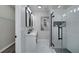 Modern bathroom with glass enclosed shower, marble floors and double vanity sinks at 944 Woodland Ave, Atlanta, GA 30316