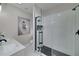 Modern bathroom with glass enclosed shower, marble floors, and stylish black hardware at 944 Woodland Ave, Atlanta, GA 30316