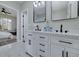 Bright bathroom with marble floors, double sinks, and a view into the adjoining bedroom at 944 Woodland Ave, Atlanta, GA 30316
