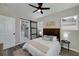 Charming bedroom with sliding barn door leading to the bathroom and modern ceiling fan at 944 Woodland Ave, Atlanta, GA 30316