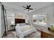 Primary bedroom boasts ample natural light, ceiling fan, hardwood floors, and neutral decor at 944 Woodland Ave, Atlanta, GA 30316
