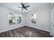 Bright bedroom featuring gray walls, new flooring, ceiling fan, and ample natural light at 944 Woodland Ave, Atlanta, GA 30316