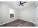Cozy bedroom featuring gray walls, new flooring, ceiling fan, and closet at 944 Woodland Ave, Atlanta, GA 30316
