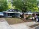 View of the charming bungalow home with a stylish brick front porch in a residential neighborhood at 944 Woodland Ave, Atlanta, GA 30316