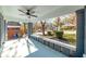 Covered front porch featuring brick columns, ceiling fan, and seating area at 944 Woodland Ave, Atlanta, GA 30316