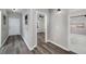 Hallway featuring gray hardwood flooring, white trim and access to a bathroom and bedroom at 944 Woodland Ave, Atlanta, GA 30316