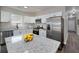 Modern kitchen with stainless appliances, granite counters, and a central island at 944 Woodland Ave, Atlanta, GA 30316