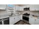 Modern kitchen features stainless appliances, granite counters, and modern sink hardware at 944 Woodland Ave, Atlanta, GA 30316