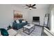 Cozy living room features a comfortable sofa, modern TV, and decorative ladder for a stylish touch at 944 Woodland Ave, Atlanta, GA 30316