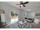Inviting living room with a view of the deck, stylish seating, and modern ceiling fan at 944 Woodland Ave, Atlanta, GA 30316