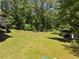 Expansive backyard features lush greenery, mature trees, and natural light at 2158 Huckleberry Ln, Lithia Springs, GA 30122