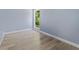 Bedroom with large window and modern vinyl plank flooring and white trim at 2158 Huckleberry Ln, Lithia Springs, GA 30122