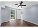 Bedroom with hardwood floors, ceiling fan, and large windows offering lots of sunlight at 2158 Huckleberry Ln, Lithia Springs, GA 30122