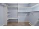 Spacious closet with custom shelving, wood laminate flooring, and electrical outlets at 2158 Huckleberry Ln, Lithia Springs, GA 30122