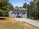 Charming two-story home with a modern metal roof and a freshly poured concrete driveway at 2158 Huckleberry Ln, Lithia Springs, GA 30122