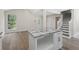 Kitchen island with granite countertop, white cabinets, and stainless steel hardware at 2158 Huckleberry Ln, Lithia Springs, GA 30122
