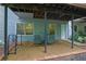 The backyard has gravel and brick floors, utility access, and is surrounded by plants and trees at 305 River Glen Dr, Roswell, GA 30075
