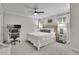 Well-lit bedroom with a ceiling fan, desk area, and soft carpet at 305 River Glen Dr, Roswell, GA 30075