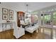Bright dining room boasts hardwood floors, table seating, and backyard access, perfect for Gathering dinners at 305 River Glen Dr, Roswell, GA 30075