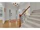 Bright foyer with hardwood floors, staircase, and a front door view creating an inviting entryway at 305 River Glen Dr, Roswell, GA 30075