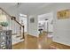 Bright foyer showcasing hardwood floors, stairs, and entry to the kitchen, creating an inviting space at 305 River Glen Dr, Roswell, GA 30075