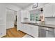 Well-lit kitchen with white cabinetry, subway tile backsplash, granite countertops, and stainless steel appliances at 305 River Glen Dr, Roswell, GA 30075